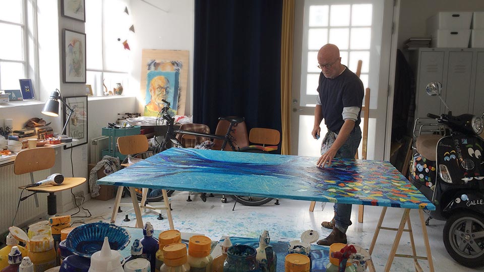 Danish artist and portrait painter Peter Simonsen working in his studio at PS Art Gallery